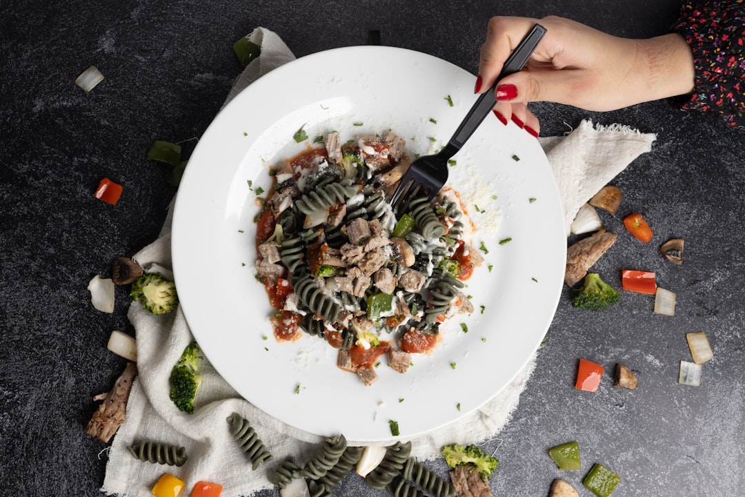 a-plate-of-pasta-with-meat-and-vegetables-exxbe93vq-y