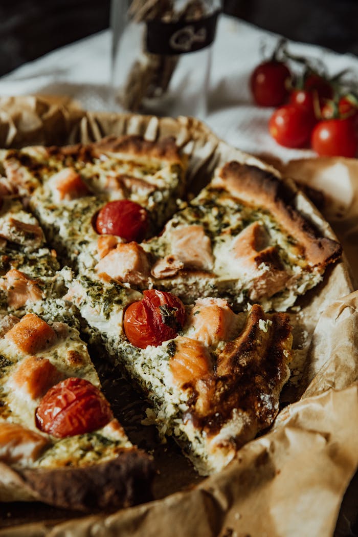 Mouthwatering quiche with cheese, salmon, and cherry tomatoes; perfect for healthy eating.